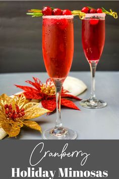 two glasses filled with cranberry mimosas on top of a table