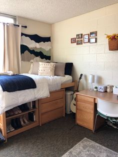 a bedroom with two beds and a desk