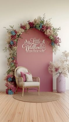 a chair sitting on top of a wooden floor next to a pink wall