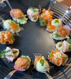 a black plate topped with different types of appetizers