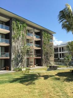 an apartment building with plants growing on it's sides and balconies in the windows