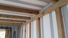 the inside of a house being built with wood framing and insulation tape on the walls