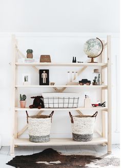 two baskets sitting on top of a wooden shelf