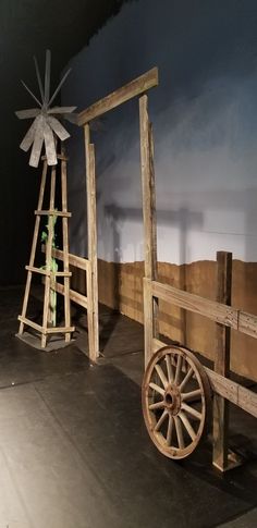 an old wagon and windmill on display in a museum