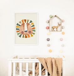 a baby's room with a lion print on the wall