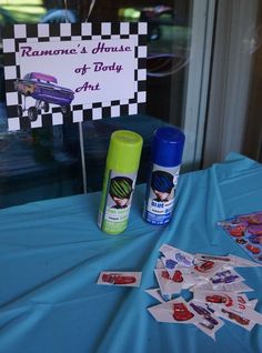 a blue table topped with lots of items next to a sign