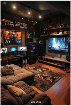 a living room filled with lots of furniture and two large tvs mounted to the wall