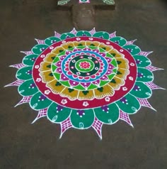 a colorful flower design is on the ground