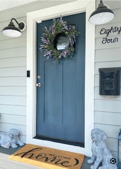 a blue front door with a wreath on it