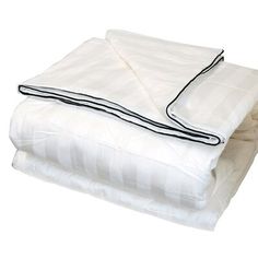 the white sheets are folded on top of each other and have black trimmings