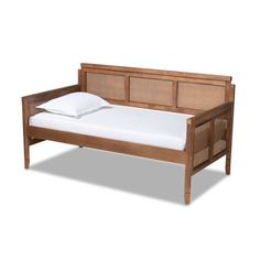 the bed frame is made from wood and has white sheets on it, along with a pillow