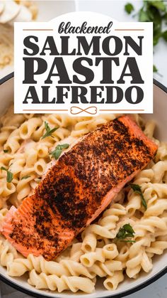 Blackened salmon fillet on creamy Alfredo pasta.