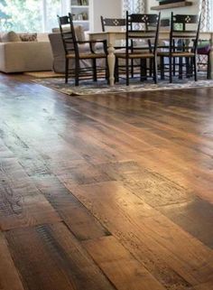 a living room with wooden floors and furniture