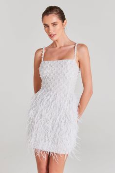 a woman wearing a white feather dress