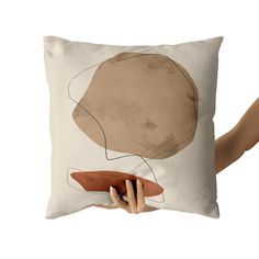 a person holding a pillow with an image of a woman's head on it