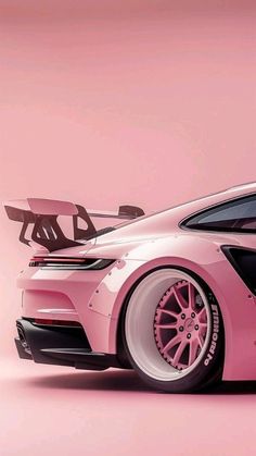 a pink sports car parked in front of a pink wall