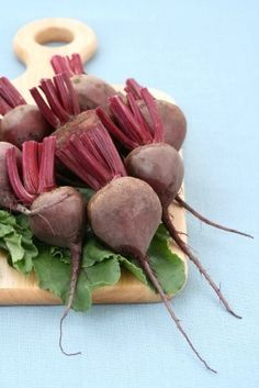 beets and lettuce are on a cutting board