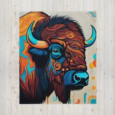 a painting of a bison with blue, orange and yellow colors on it's face