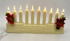 a white hanukkah with lit candles and poinsettis on it