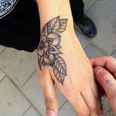 a person with a tattoo on their hand