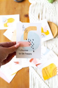 someone holding up a card that says i choose to be happy