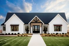 a white house with black roof and windows