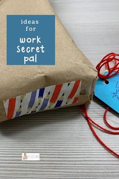 a piece of brown paper sitting on top of a table next to a blue tag