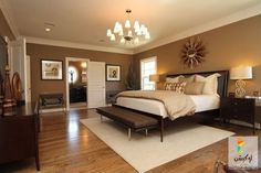 a large bed sitting in the middle of a bedroom on top of a hard wood floor