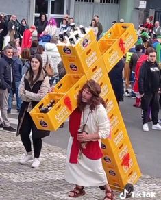 a man carrying a large yellow cross on top of it's back in the street