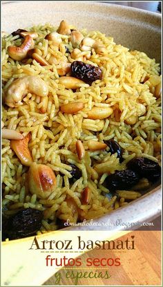 a bowl filled with rice, nuts and raisins