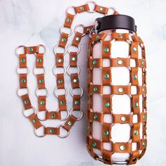 Genuine one-of-a-kind, leather water bottle holder with stud details and stainless steel hardware. It's the perfect festival pack! Why be the highest in the room when you can be the most hydrated! Are you starting to get judged more and more by your peers, coworkers, or 711 employees when purchasing and carrying around plastic water bottles? Are you ready to finally make the switch to a reusable one? Are you scared of looking like a swagless nerd if you do it? Are you worried it will be too bulk Leather Water Bottle Holder, Leather Water Bottle, Highest In The Room, Diy Projects To Make And Sell, Leather Bag Design, Water Bottle Bag, Diy Leather Bag, Water Bottle Holder, Water Bottle Holders