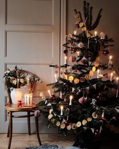 a decorated christmas tree with candles and ornaments