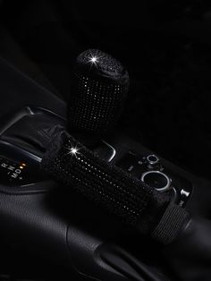 the interior of a car with black leather and crystal decorations on it's dashboard