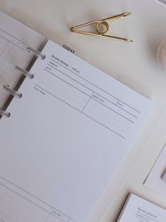 a binder, clipboard and pen on a desk