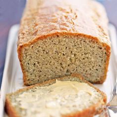 a loaf of bread sitting on top of a table next to a knife and fork