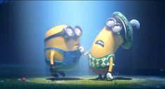 two minion characters standing next to each other in front of a blue light and grass field