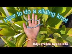 someone is holding their hand up in front of some leaves with the words how to do a sliding knot