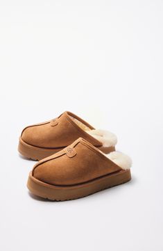 Plush comfort and the UGG look you know and love are both in store when you step into this slide slipper made from genuine shearling in an array of hues. 2 1/4" heel; 1 1/2" platform (size 11) Slight dye transfer may occur with darker colors during first few wears Genuine-shearling upper and lining/synthetic sole Shearling may be sourced from Australia, Ireland, Spain, the UK or the USA. See packaging for confirmed country of origin Imported Slip On Uggs, Uggs Boots, Nylon Travel Bag, Buy Boots, Shearling Slippers, Emily Henderson, Ugg Slippers, Cute Boots, Nordstrom Anniversary Sale