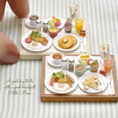 two miniature plates with breakfast foods on them