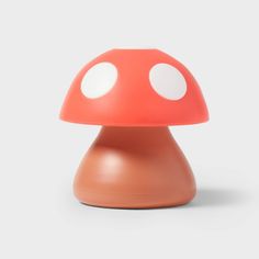 an orange mushroom lamp with white dots on it