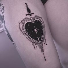 a woman's thigh with a heart tattoo on it