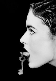 a woman holding a key to her mouth