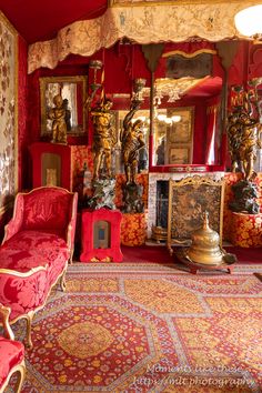 an ornately decorated living room with red and gold furniture