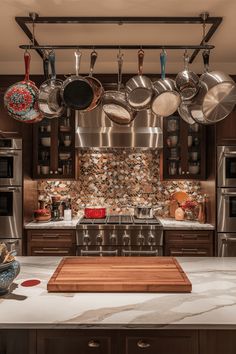 a kitchen with many pots and pans hanging from the ceiling over the stove top