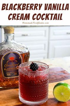 the blackberry vanilla cream cocktail is garnished with fresh blackberries and limes