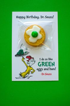 a dr seuss cupcake with white frosting and green eyes on it's wrapper