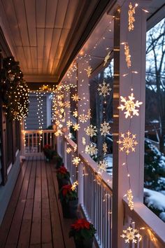 snowflakes are hanging on the front porch for christmas lights to hang from the ceiling