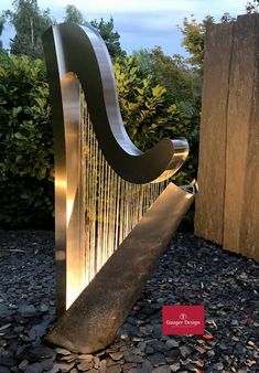 a large metal harp sitting on top of a pile of rocks