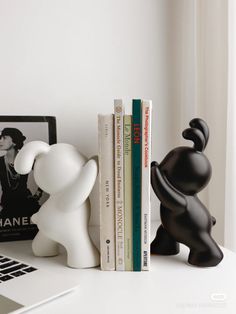 a couple of books sitting on top of a white desk