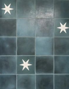 an artistic tile design with white stars on it